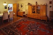 My childhood home: living room with dining table and kitchen door